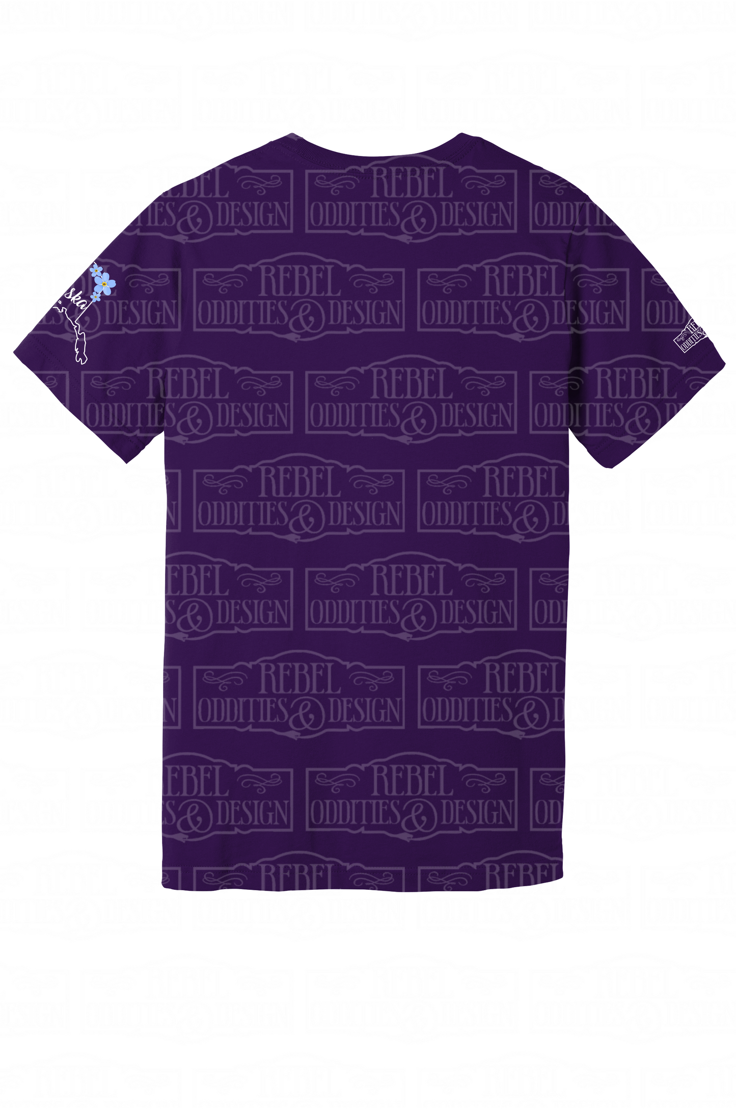 The back of the Purple t-shirt with the shape of Alaska on the left sleeve, a small logo on the right sleeve, and a Forget-Me-Not and Fireweed design on the front against a white background. There is nothing on the back of the shirt.