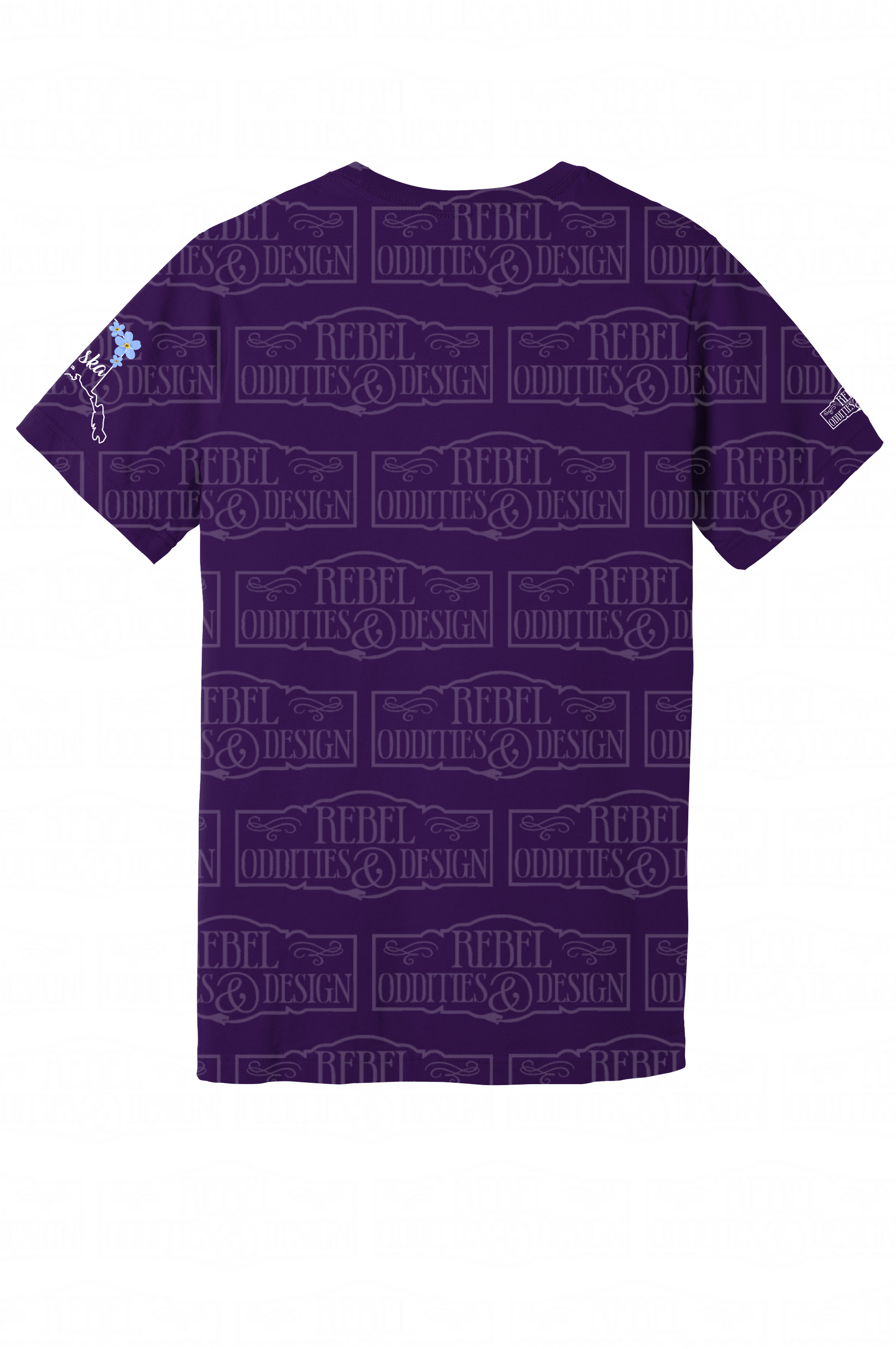 The back of the Purple t-shirt with the shape of Alaska on the left sleeve, a small logo on the right sleeve, and a Forget-Me-Not and Fireweed design on the front against a white background. There is nothing on the back of the shirt.